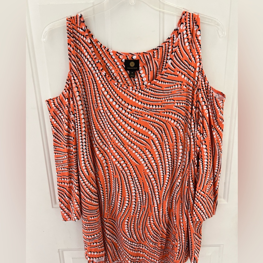 Women’s cold shoulder knit top. 3/4 sleeve. Orange, black, white. Size 3X.